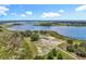 Scenic aerial view featuring a beautiful lakefront property with a well-maintained home and surrounding greenery at 14243 County Road 450, Umatilla, FL 32784
