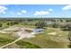 Expansive aerial view showcasing the home's large lot, mature trees, and serene pond at 14243 County Road 450, Umatilla, FL 32784