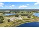 Breathtaking aerial perspective showcasing the home's serene setting amidst multiple lakes and lush landscapes at 14243 County Road 450, Umatilla, FL 32784