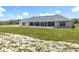 Rear view of a home with a covered patio, showcasing an ideal outdoor space for relaxation and entertainment at 14243 County Road 450, Umatilla, FL 32784