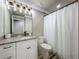 Bathroom with granite countertops, shower with curtain and modern lighting at 14243 County Road 450, Umatilla, FL 32784