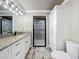 Bathroom vanity with double sinks, granite counters, a modern shower, and toilet at 14243 County Road 450, Umatilla, FL 32784