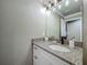 Bathroom featuring granite countertop, white vanity and modern lighting at 14243 County Road 450, Umatilla, FL 32784