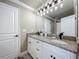 Bright bathroom featuring a double vanity with granite counters and modern lighting at 14243 County Road 450, Umatilla, FL 32784