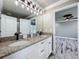 Bathroom vanity with double sinks, granite counters, and access to the bedroom at 14243 County Road 450, Umatilla, FL 32784