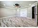 Bedroom with a ceiling fan and a closet, offering lots of storage, and neutral paint and wood-look flooring at 14243 County Road 450, Umatilla, FL 32784