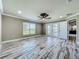 Open concept bedroom with a ceiling fan, window, and doors to the outside at 14243 County Road 450, Umatilla, FL 32784