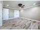 Bedroom with wood-look tile flooring, ceiling fan, crown molding, and closet at 14243 County Road 450, Umatilla, FL 32784