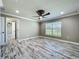 Bedroom featuring ceiling fan, window and wood-look floors at 14243 County Road 450, Umatilla, FL 32784