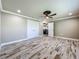 Bedroom with a closet, ceiling fan, and neutral paint, featuring wood-look tile flooring at 14243 County Road 450, Umatilla, FL 32784