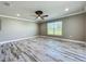 Open concept bedroom with a ceiling fan and window, showcasing natural light at 14243 County Road 450, Umatilla, FL 32784