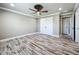 Bedroom featuring wood-look floors, ceiling fan, crown molding and closet at 14243 County Road 450, Umatilla, FL 32784