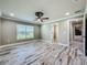 Spacious bedroom with wood-look tile flooring, ceiling fan and a view to the front at 14243 County Road 450, Umatilla, FL 32784