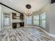 Dining room area with built-in desk, modern chandelier, and wood-look tile flooring, lots of natural light at 14243 County Road 450, Umatilla, FL 32784