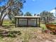 Enclosed shed offering functional outdoor storage on a spacious, well-maintained lawn at 14243 County Road 450, Umatilla, FL 32784