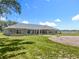 Charming exterior with stone accents, manicured lawn, and a view of the water at 14243 County Road 450, Umatilla, FL 32784