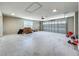 Spacious, unfinished garage with a large overhead door and natural light from a window at 14243 County Road 450, Umatilla, FL 32784