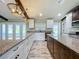 Bright kitchen showcasing granite counters, white cabinetry, stainless steel appliances and wood-look tile floors at 14243 County Road 450, Umatilla, FL 32784