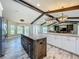 Open kitchen featuring two islands with granite countertops, modern lighting, and wood-look flooring at 14243 County Road 450, Umatilla, FL 32784