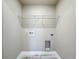 Unfinished laundry room with utility connections and a single wire shelf at 14243 County Road 450, Umatilla, FL 32784