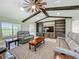 Inviting living room with vaulted ceilings, exposed beams, and a custom built-in entertainment center at 14243 County Road 450, Umatilla, FL 32784