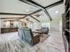 Spacious living room with vaulted ceilings, exposed beams, and hardwood-style flooring at 14243 County Road 450, Umatilla, FL 32784