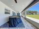 Covered outdoor patio features a ceiling fan, scenic views, and ample space at 14243 County Road 450, Umatilla, FL 32784