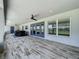 Covered outdoor patio with ceiling fans, blue trim, and scenic views at 14243 County Road 450, Umatilla, FL 32784