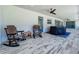 Inviting outdoor patio with ceiling fan, rocking chairs, and a scenic view at 14243 County Road 450, Umatilla, FL 32784