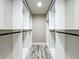 Spacious walk-in closet with custom white shelving and modern black hardware at 14243 County Road 450, Umatilla, FL 32784