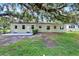 The backyard features a patio with a home shaded by a large tree at 1506 S Elliott St, Sanford, FL 32771