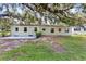 The backyard features a patio with a home shaded by a large tree at 1506 S Elliott St, Sanford, FL 32771
