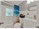 Bright white bathroom with a decorative shower curtain and vanity at 1506 S Elliott St, Sanford, FL 32771