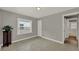 Bedroom with neutral paint, tile floors, paneled walls and access to a bathroom at 1506 S Elliott St, Sanford, FL 32771