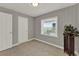 Corner bedroom featuring paneled walls, tiled floors and a door for entry and exit at 1506 S Elliott St, Sanford, FL 32771