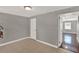Bedroom with tiled floors, neutral paint, and direct access to the next room at 1506 S Elliott St, Sanford, FL 32771