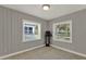 Corner bedroom featuring paneled walls and dual windows for ample natural light at 1506 S Elliott St, Sanford, FL 32771