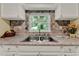 Kitchen sink with granite countertops and view of backyard at 1506 S Elliott St, Sanford, FL 32771