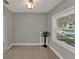 Bright living room with neutral paint, tiled floor, and natural light from a large window at 1506 S Elliott St, Sanford, FL 32771