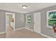 Sun-filled living room featuring neutral paint, tile flooring, and an exterior door and windows at 1506 S Elliott St, Sanford, FL 32771