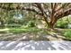 The outbuilding sits on a lush lawn beneath an old oak tree at 1506 S Elliott St, Sanford, FL 32771