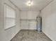 Utility room with a water heater, window and storage shelf at 1506 S Elliott St, Sanford, FL 32771
