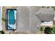 An overhead view shows the roof of this home and its screened-in swimming pool at 1614 Oak Hill Trl, Kissimmee, FL 34747