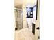 Updated bathroom with walk-in shower, marbled walls, dark vanity, and modern fixtures at 1614 Oak Hill Trl, Kissimmee, FL 34747