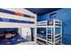 Playful bedroom showcasing two sets of bunk beds and vibrant space-themed decor for an imaginative atmosphere at 1614 Oak Hill Trl, Kissimmee, FL 34747