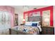 Brightly decorated bedroom with floral bedding, pink curtains, floral wallpaper, and chandelier at 1614 Oak Hill Trl, Kissimmee, FL 34747