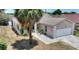 Charming single-story home featuring a two-car garage, covered porch, and well-maintained landscaping at 1614 Oak Hill Trl, Kissimmee, FL 34747