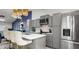 This kitchen offers modern appliances, a breakfast bar, pendant lighting, and ample cabinet space at 1614 Oak Hill Trl, Kissimmee, FL 34747