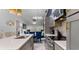 Modern kitchen with stainless steel appliances, island with chairs, grey cabinets, and open floor plan at 1614 Oak Hill Trl, Kissimmee, FL 34747