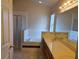 Bright bathroom featuring a bathtub, shower, and a double sink vanity with a large mirror and lighting fixture above at 1797 Tillstream Dr, Orlando, FL 32818